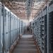server room aisle with metal equipment racks