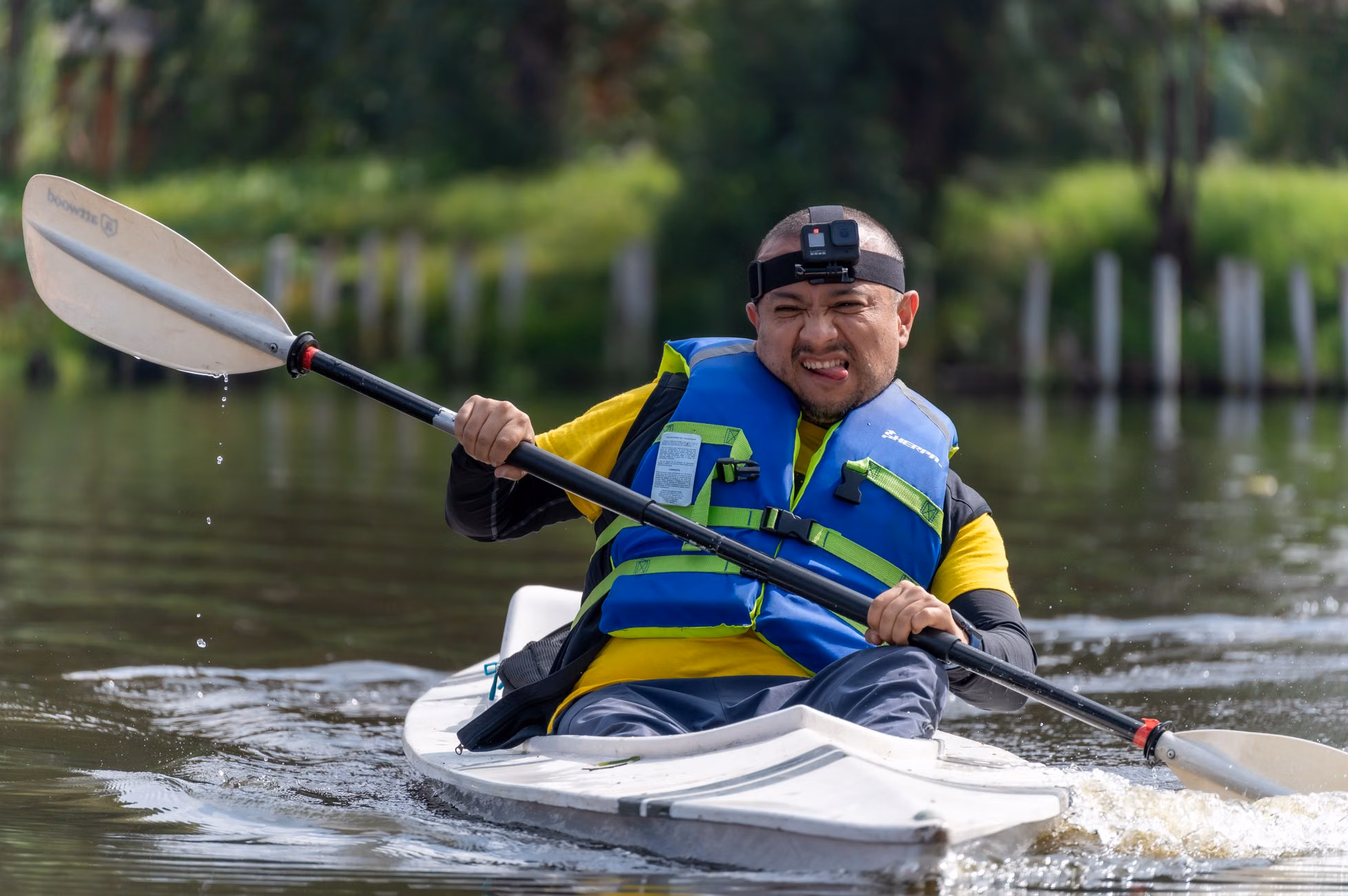 Man enjoying kayaking on a calm river in Mexico, showcasing adventure and outdoor fun.