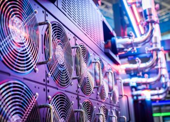 Close-up of server cooling fans in a vibrant data center.