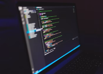 Laptop displaying code in a dark setting, highlighting programming concepts and digital work.