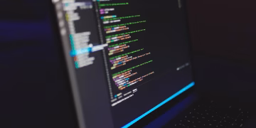 Laptop displaying code in a dark setting, highlighting programming concepts and digital work.