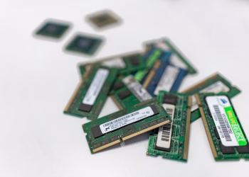 Assorted RAM modules scattered on a white surface, showcasing technology components.