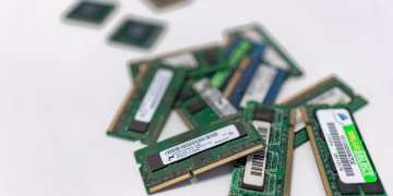 Assorted RAM modules scattered on a white surface, showcasing technology components.