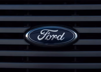 Detailed view of a Ford emblem mounted on a vehicle grille, showcasing modern design.