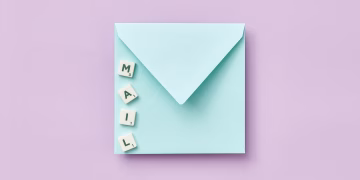 Minimalist flat lay showing a blue envelope and 'MAIL' spelled with Scrabble tiles on a purple background.