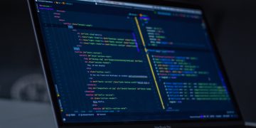 turned-on MacBook Pro wit programming codes display