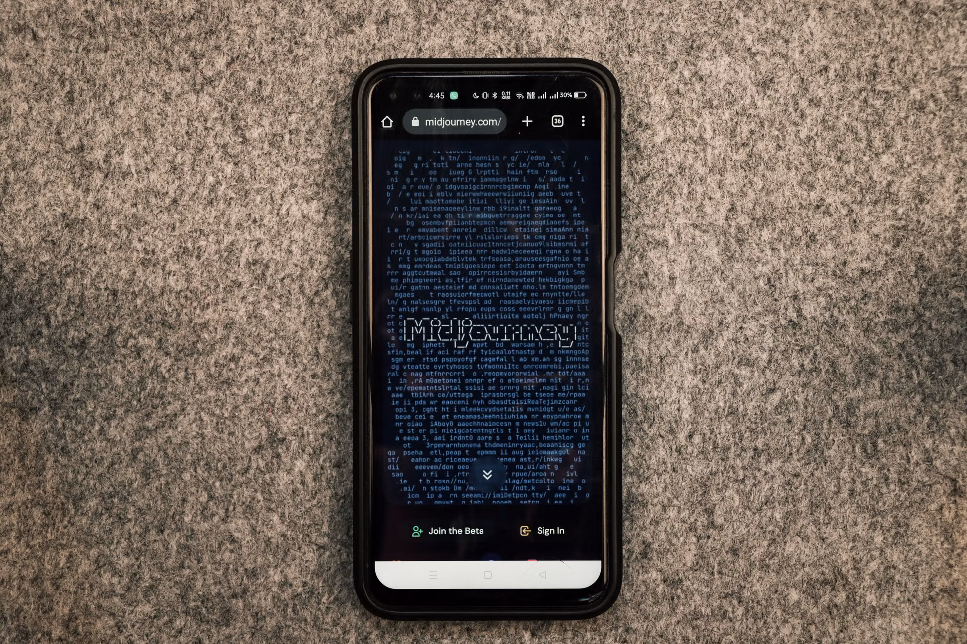 A smartphone showing the Midjourney website on its screen against a gray textured surface.