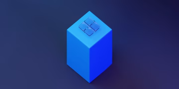 Geometric 3D render of a blue cube with glass panels on top, against a blue background.