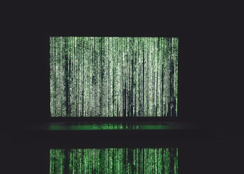 Abstract depiction of green matrix code on a computer monitor.