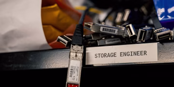 Low angle of various connectors and USB cables placed on shelf with storage engineer inscription