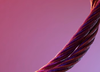Detailed close-up of twisted metal wires against a gradient purple background, showcasing texture and color contrast.
