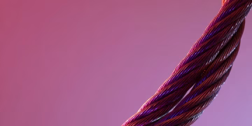 Detailed close-up of twisted metal wires against a gradient purple background, showcasing texture and color contrast.