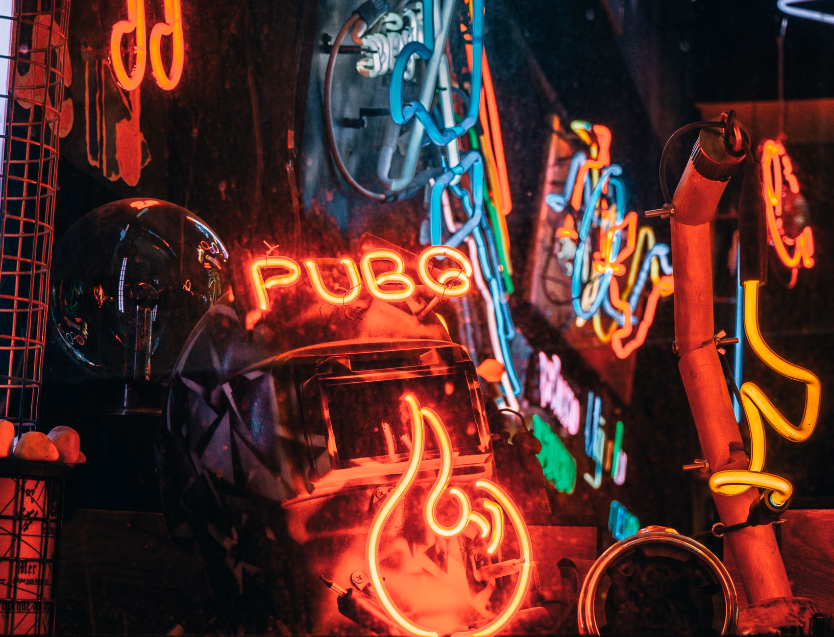 Colorful neon signs and reflections create a vibrant scene in İstanbul's nightlife.