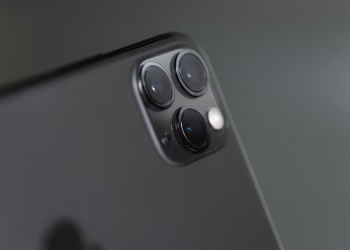 Detailed close-up of triple-camera system on a smartphone, showcasing modern technology.