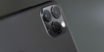 Detailed close-up of triple-camera system on a smartphone, showcasing modern technology.