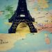 Miniature Eiffel Tower placed on a map of Europe, focusing on France.