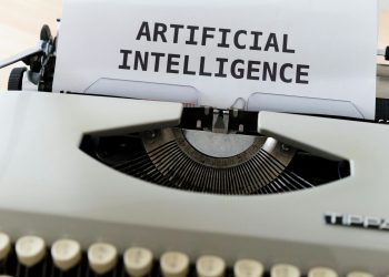 A close-up of a typewriter showcasing 'ARTIFICIAL INTELLIGENCE' on paper.