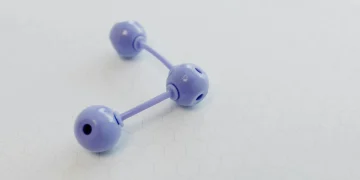 Abstract representation of a molecular structure using a purple plastic model on hexagonal patterned paper.