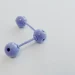 Abstract representation of a molecular structure using a purple plastic model on hexagonal patterned paper.