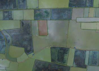 Stunning aerial photo of Bangladesh's patchwork rice fields from above, showcasing vibrant greenery.