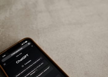 A smartphone displays the ChatGPT interface on its screen, symbolizing modern AI technology.