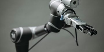 Close-up view of a robotic arm equipped with a video camera, showcasing modern technology.