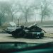 A foggy morning with a severely damaged car on a deserted street in Chicago.