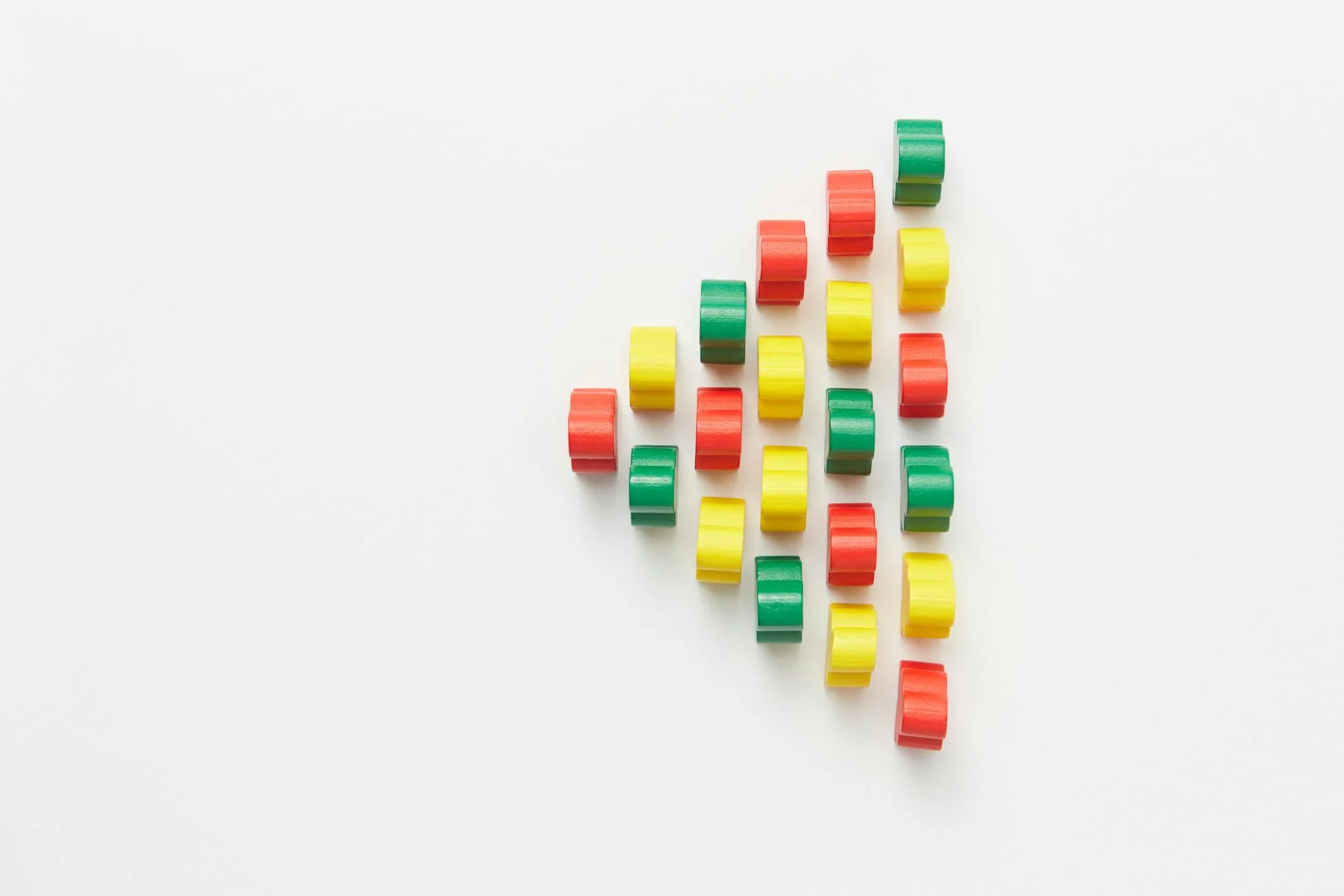Vibrant arrangement of colorful plastic pieces on a white background forming a geometric pattern.