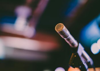 Detailed shot of a microphone with artistic bokeh background, ideal for concerts.