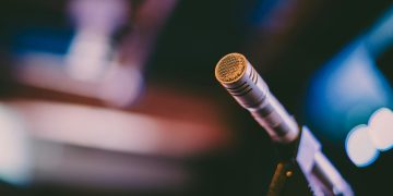 Detailed shot of a microphone with artistic bokeh background, ideal for concerts.
