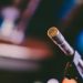 Detailed shot of a microphone with artistic bokeh background, ideal for concerts.