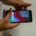 Close-up image of hands holding a smartphone receiving a call from Ruby on a marble surface.