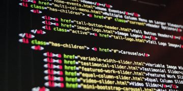 Close-up of HTML code highlighted in vibrant colors on a computer monitor.