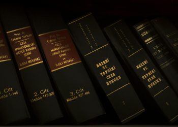 Stack of legal and literature books in a library showcasing various volumes.