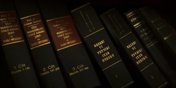 Stack of legal and literature books in a library showcasing various volumes.