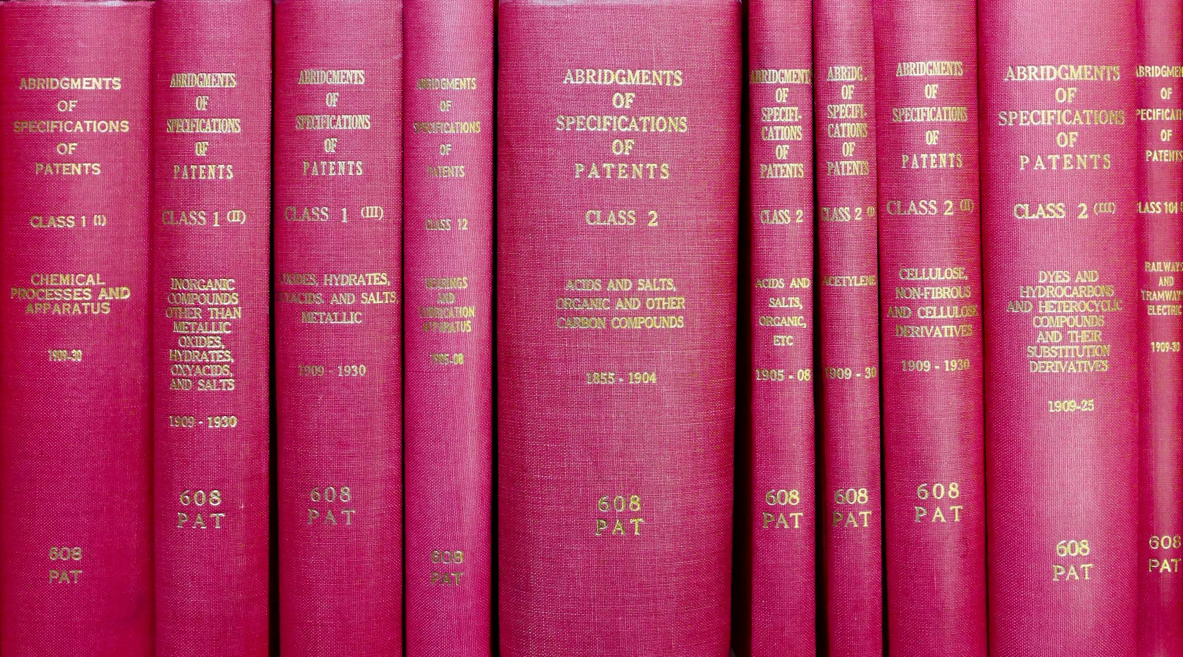 A row of red hardcover books titled 'Abridgments of Specifications of Patents'.