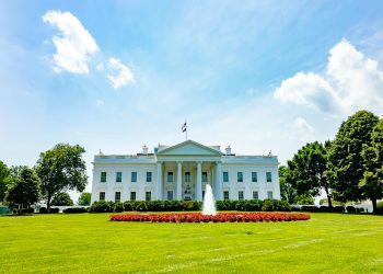 The iconic White House lawn and fountain on a bright summer day in Washington, DC.