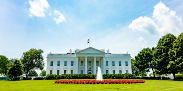 The iconic White House lawn and fountain on a bright summer day in Washington, DC.