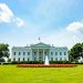 The iconic White House lawn and fountain on a bright summer day in Washington, DC.