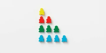Vivid multi-colored game pieces arranged in a strategic pyramid on white background, offering a vibrant visual pattern.