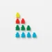 Vivid multi-colored game pieces arranged in a strategic pyramid on white background, offering a vibrant visual pattern.