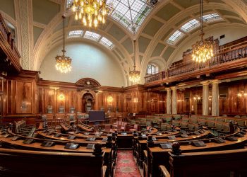 A beautifully designed chamber room with ornate woodwork and chandeliers in the UK.