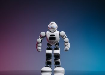 A modern toy robot standing on a gradient background, showcasing innovation and technology.