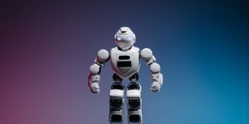 A modern toy robot standing on a gradient background, showcasing innovation and technology.
