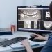 Dentist examining dental X-rays on a computer screen in a clinic.