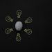 Conceptual photo of a brain surrounded by light bulb clips on black background.