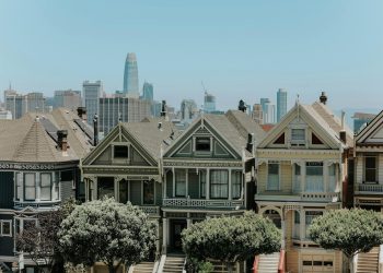 Captivating view of San Francisco's famous Victorian houses with city skyline in the background.