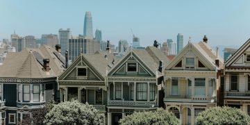 Captivating view of San Francisco's famous Victorian houses with city skyline in the background.