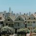 Captivating view of San Francisco's famous Victorian houses with city skyline in the background.