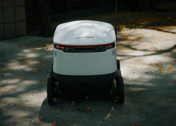 Autonomous delivery robot in urban setting, showcasing modern technology.